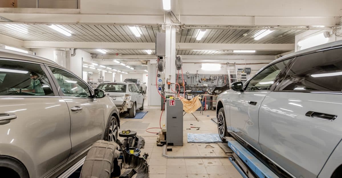 Vehicles mid-repair on a workshop floor